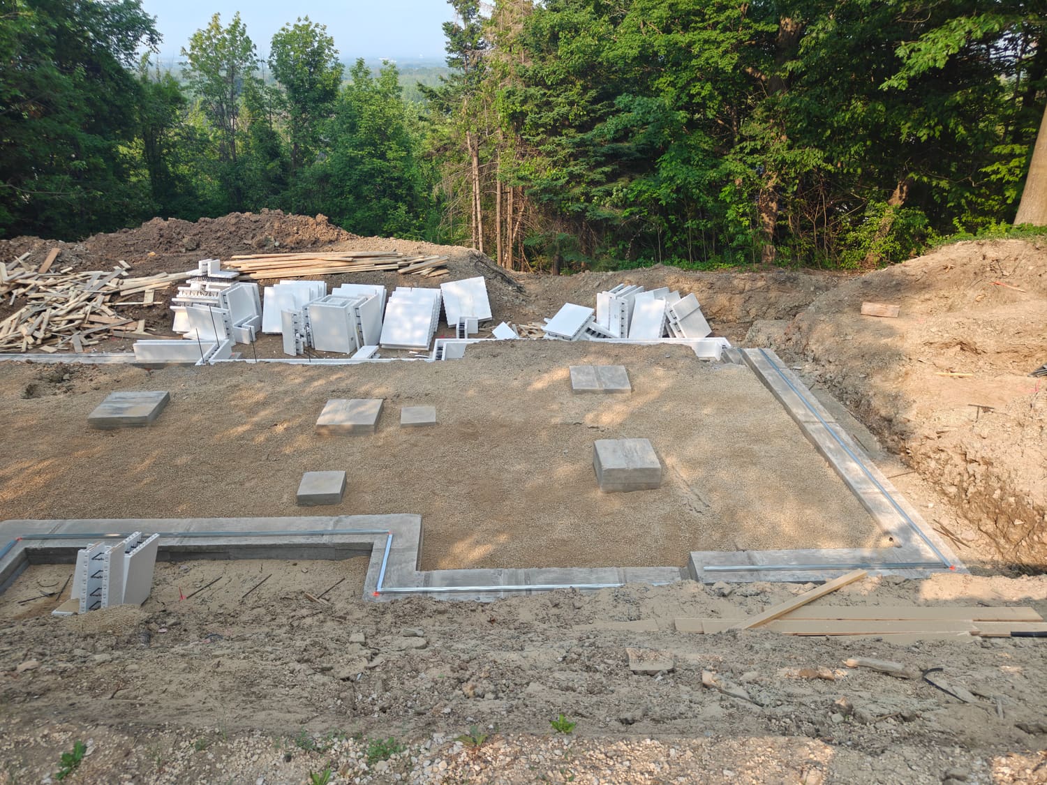 Footings and stone base formed for the 105 Orchard Lane ICF foundation in Clearview