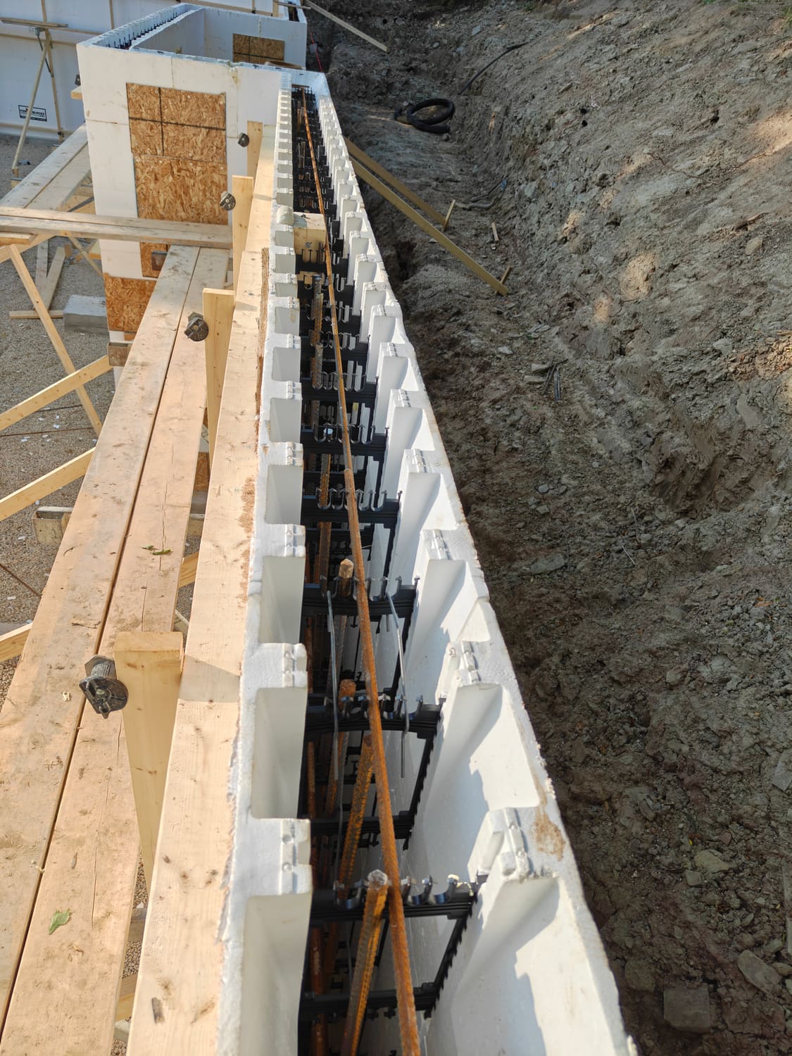Close-up of ICF wall with rebar and bracing at the 105 Orchard Lane foundation in Clearview