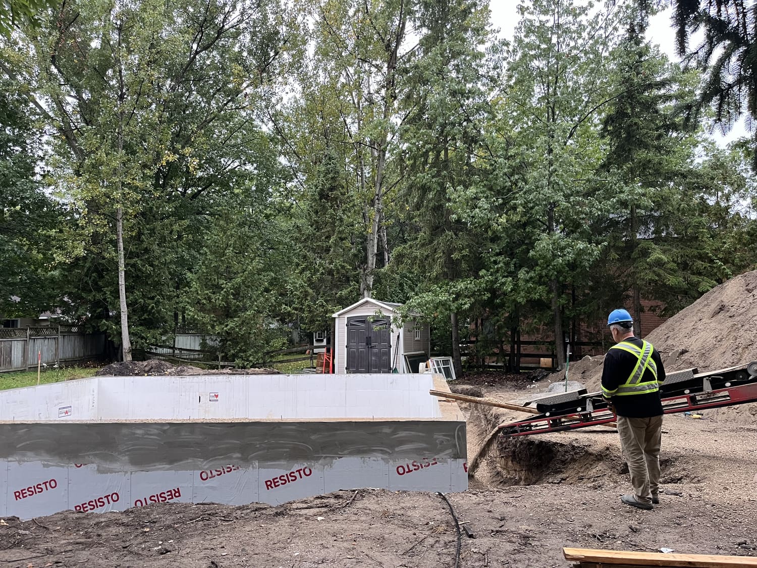 Crew member during backfilling around the ICF frost wall at 21 1st Lane in Wasaga Beach