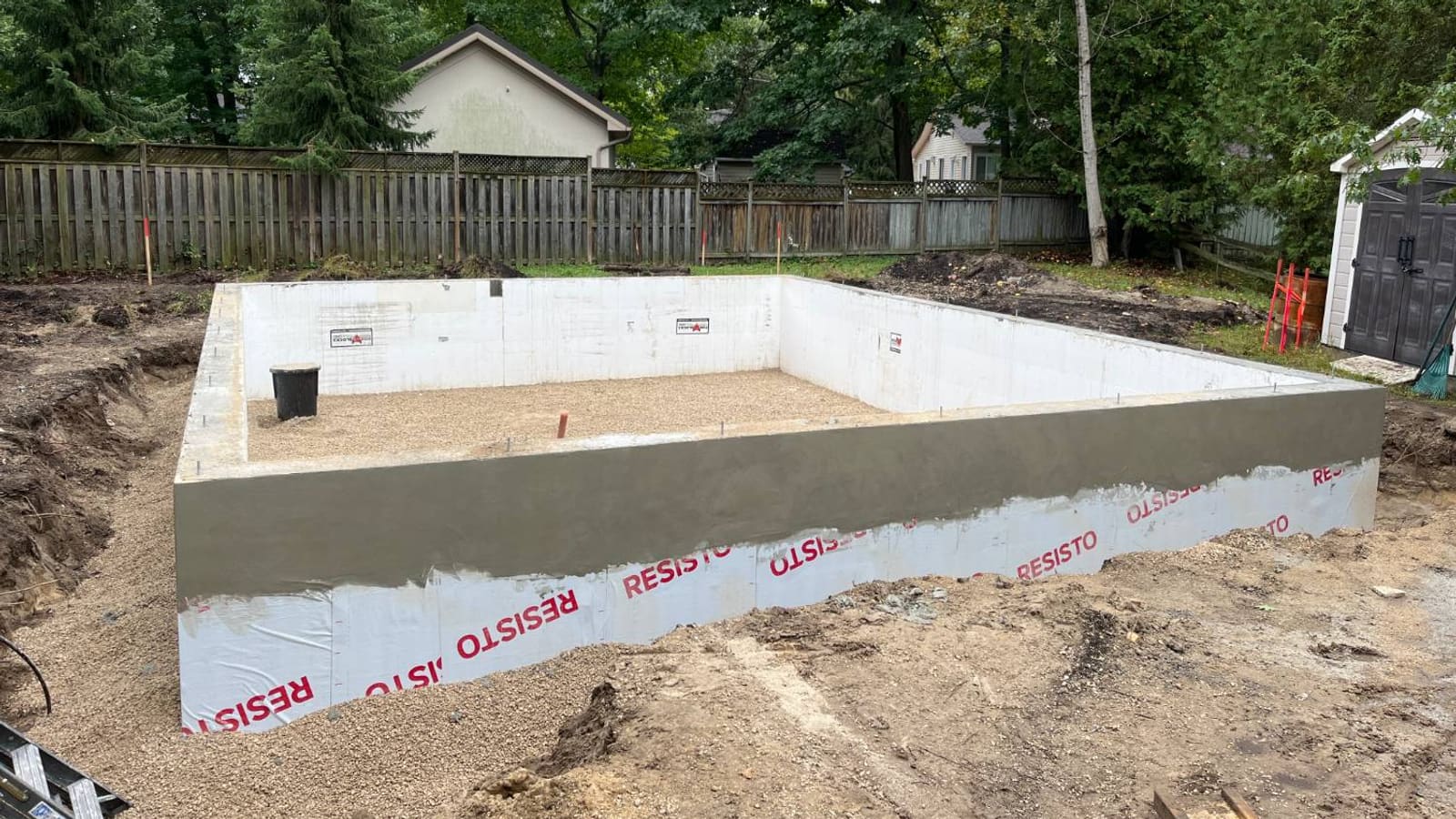 Finished ICF frost wall with exterior membrane and stone base at 21 1st Lane in Wasaga Beach