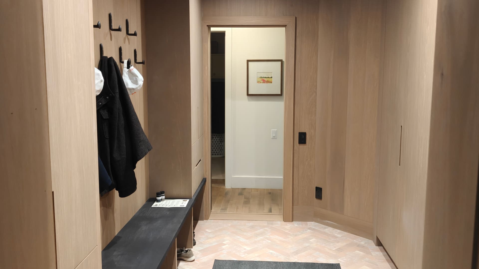 Finished mudroom with wood cabinetry and herringbone floor at 23 Forest Drive in Collingwood