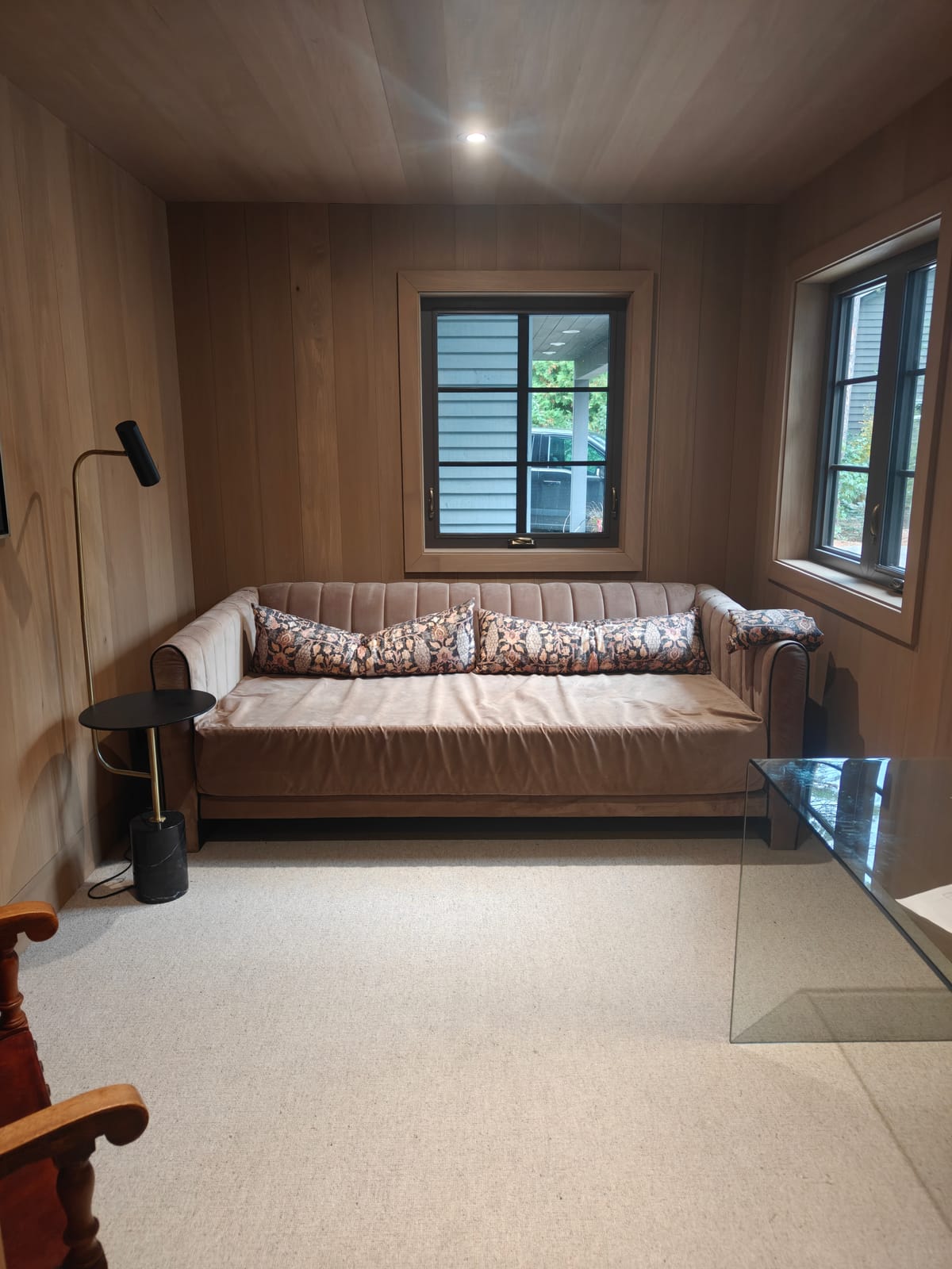 Wood-paneled home office with sofa and windows in the 23 Forest Drive renovation, Collingwood