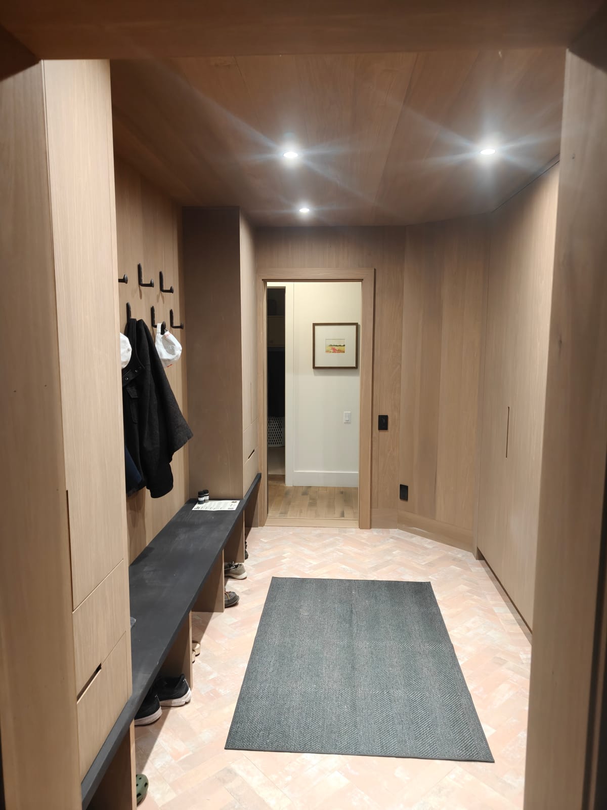 Mudroom bench, coat hooks and custom millwork in the 23 Forest Drive renovation in Collingwood