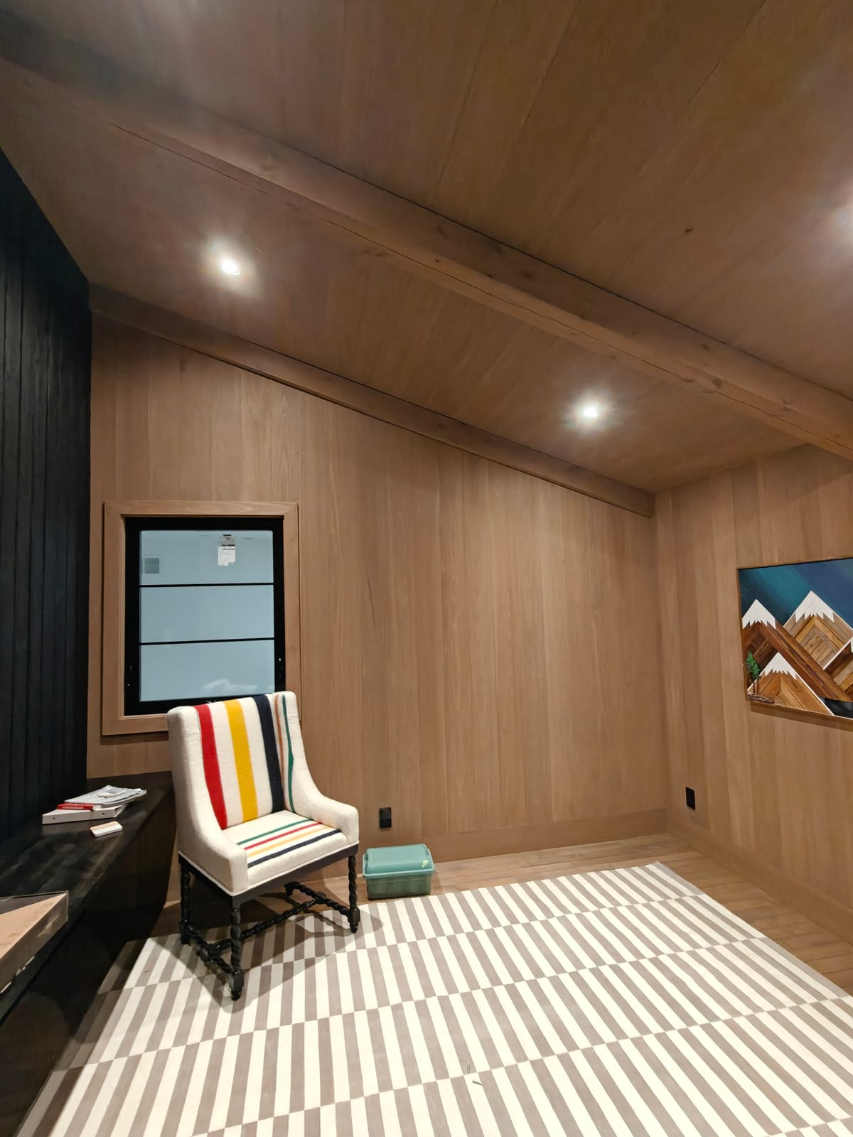 Office with sloped wood ceiling, exposed beam and wood paneling, 23 Forest Drive renovation in Collingwood