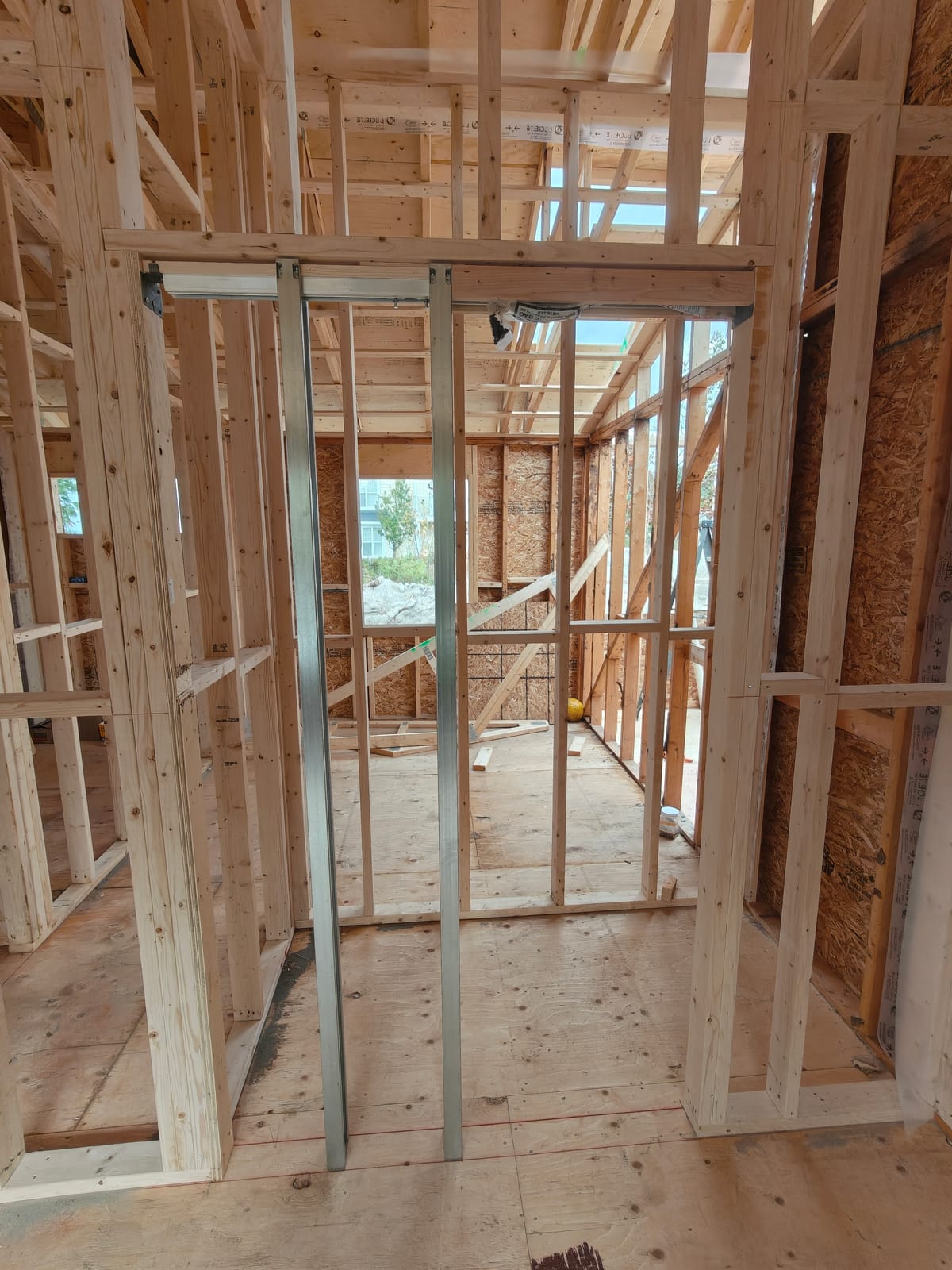Interior wall framing with steel studs and a new door opening during the 768 Shore Lane cottage renovation in Wasaga Beach